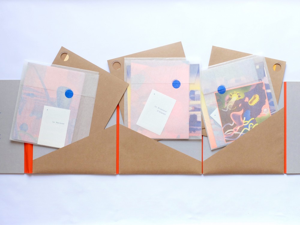 Aqualoop - Livre d'archive - 1 | L'outil à déployer, 3 compartiments, 6 pochettes : 3 en craft et 3 en papier cristal.
À l'intérieur, Risographies et sérigraphies pliées..